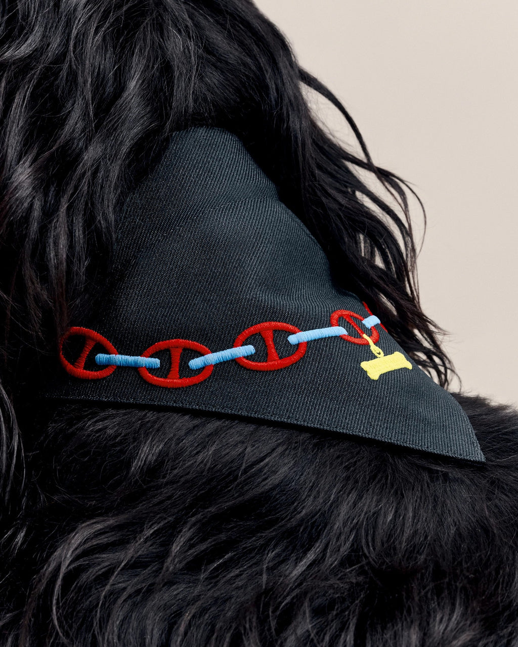Close-up of the Maillons chain print on the navy bandana